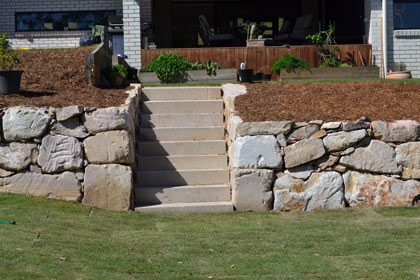 Sculptured garden with  retaining wall made from sized sandstone